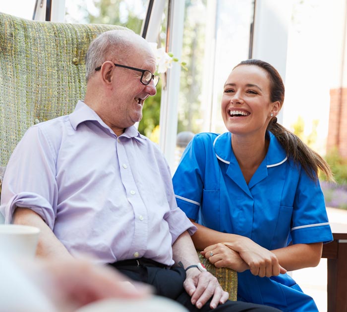 A carer laughing with a patient